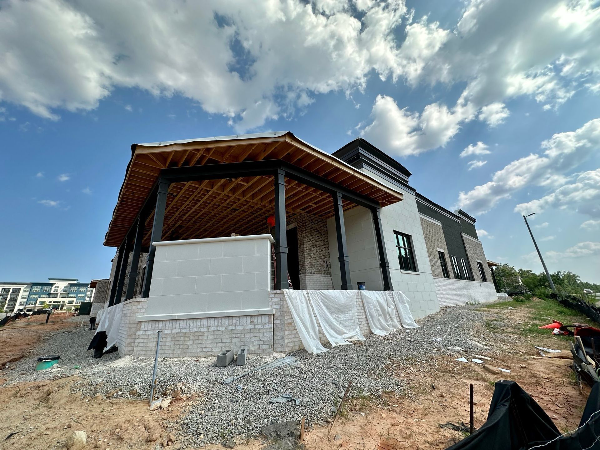 A house is being built on a hill with a porch.