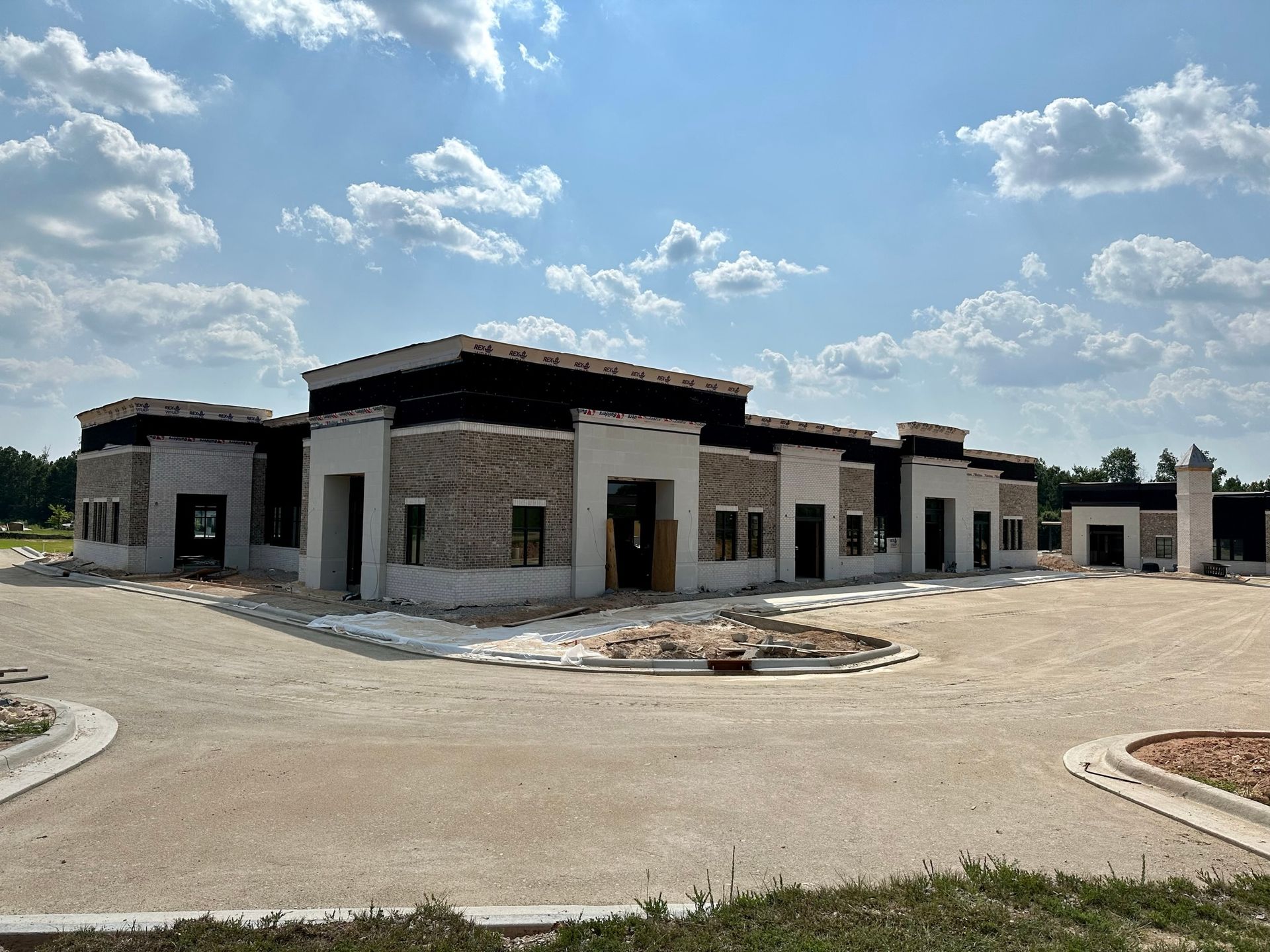 A large building under construction with a lot of windows and doors.