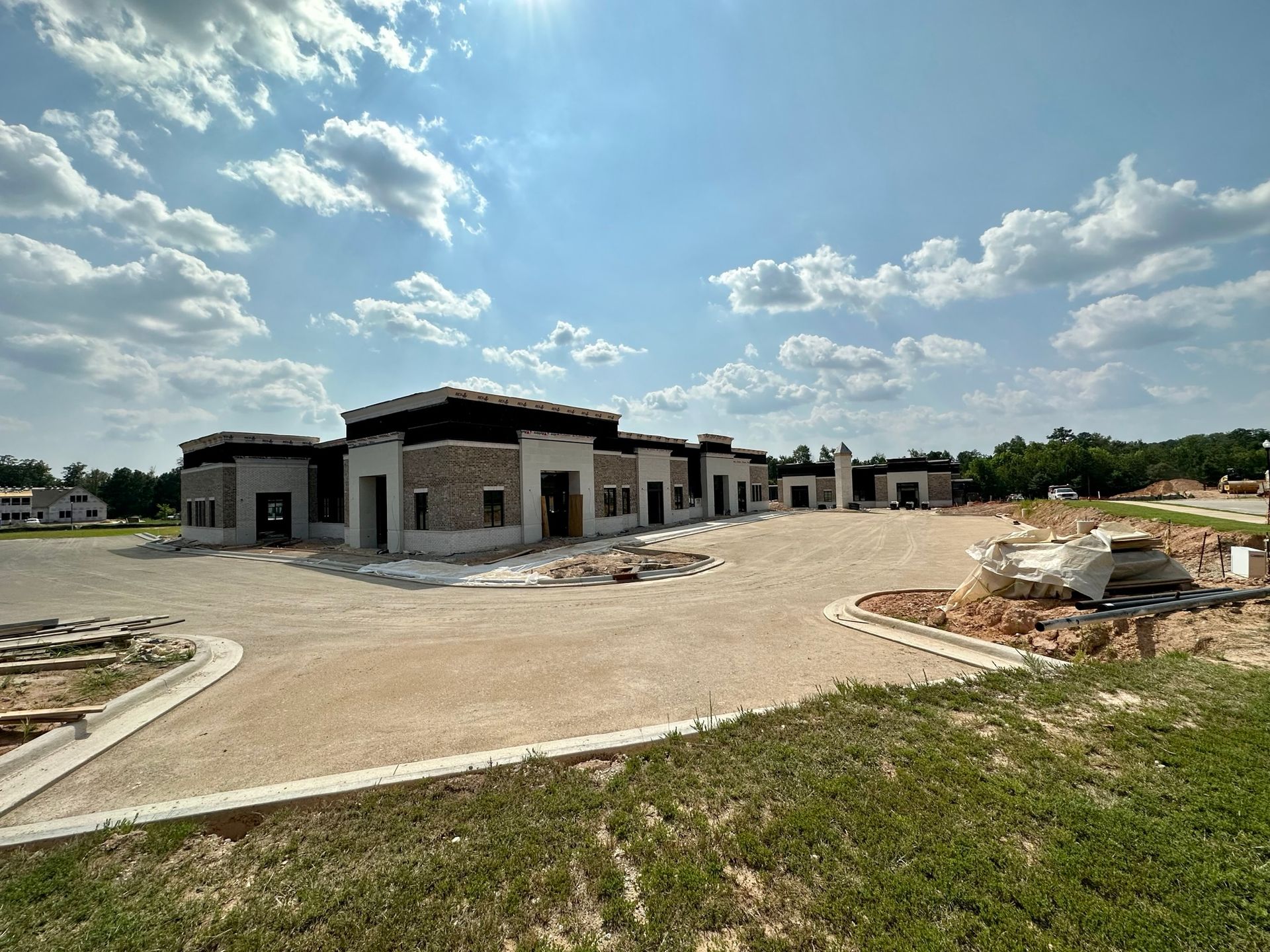 A large building is being built in the middle of a field.