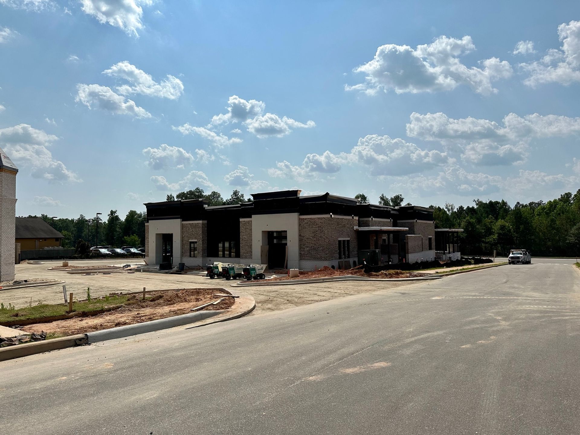 A large building is being built on the side of the road.