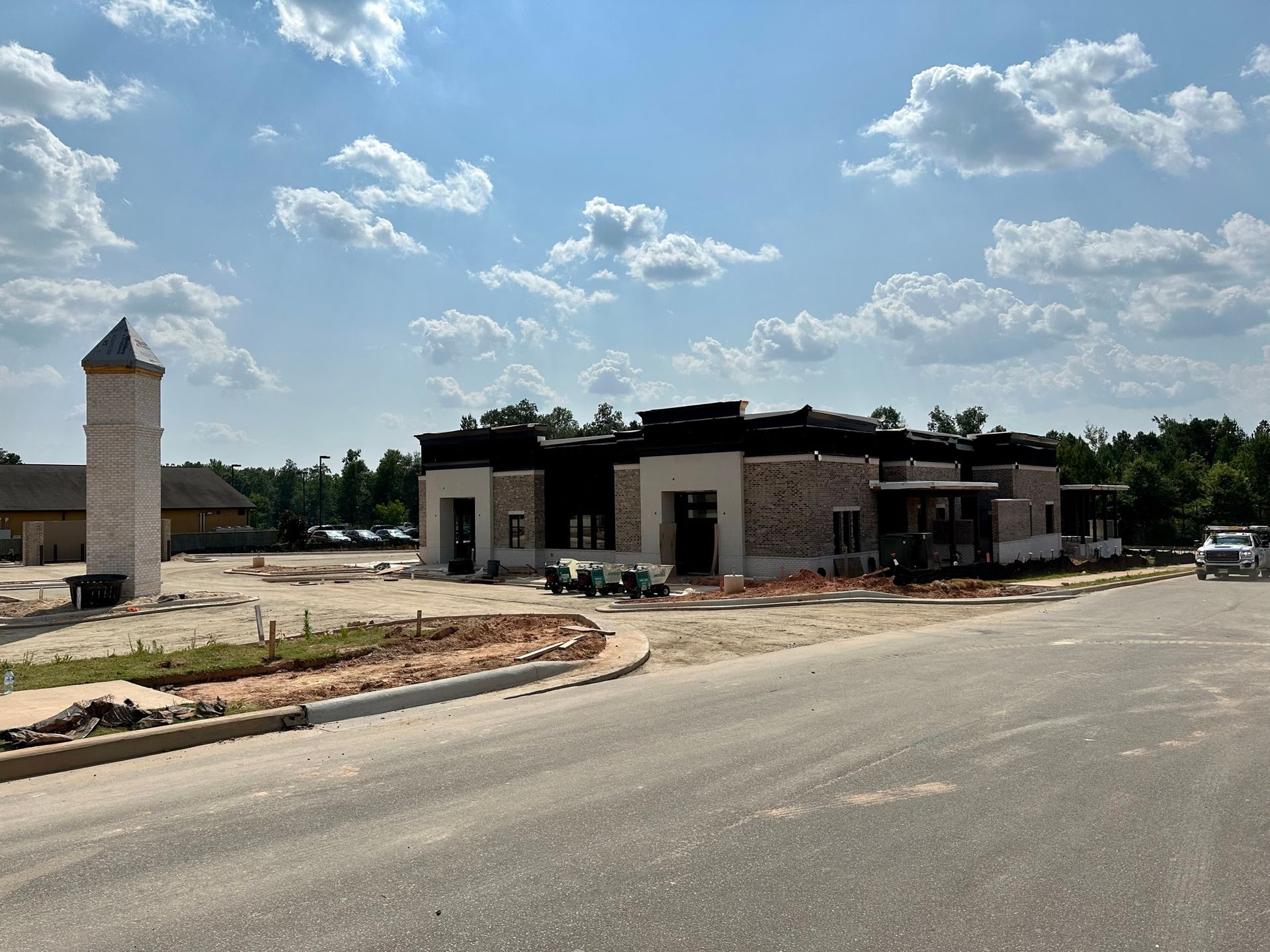 A large building is being built on the side of the road.