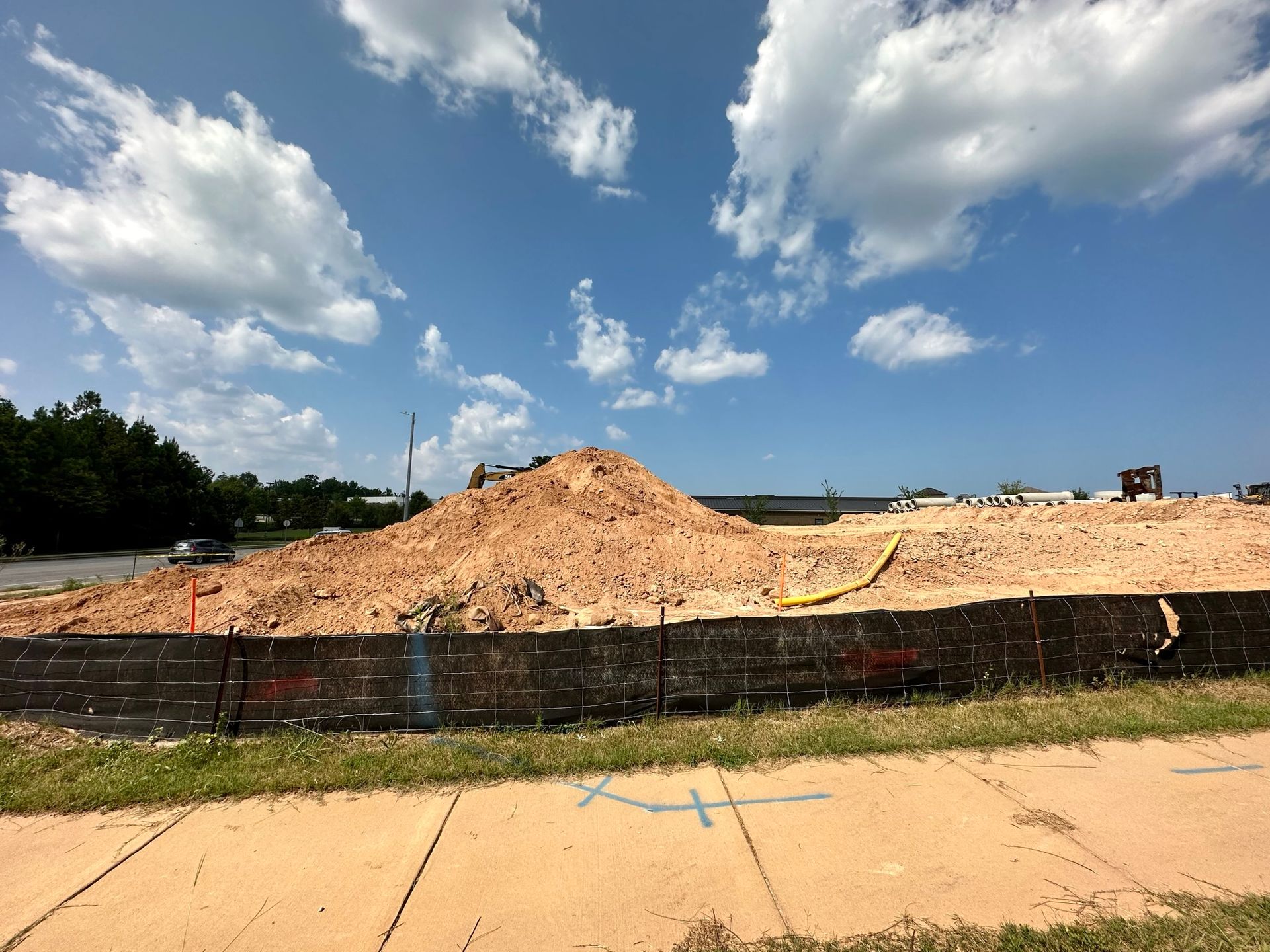 A large pile of dirt is sitting on the side of the road