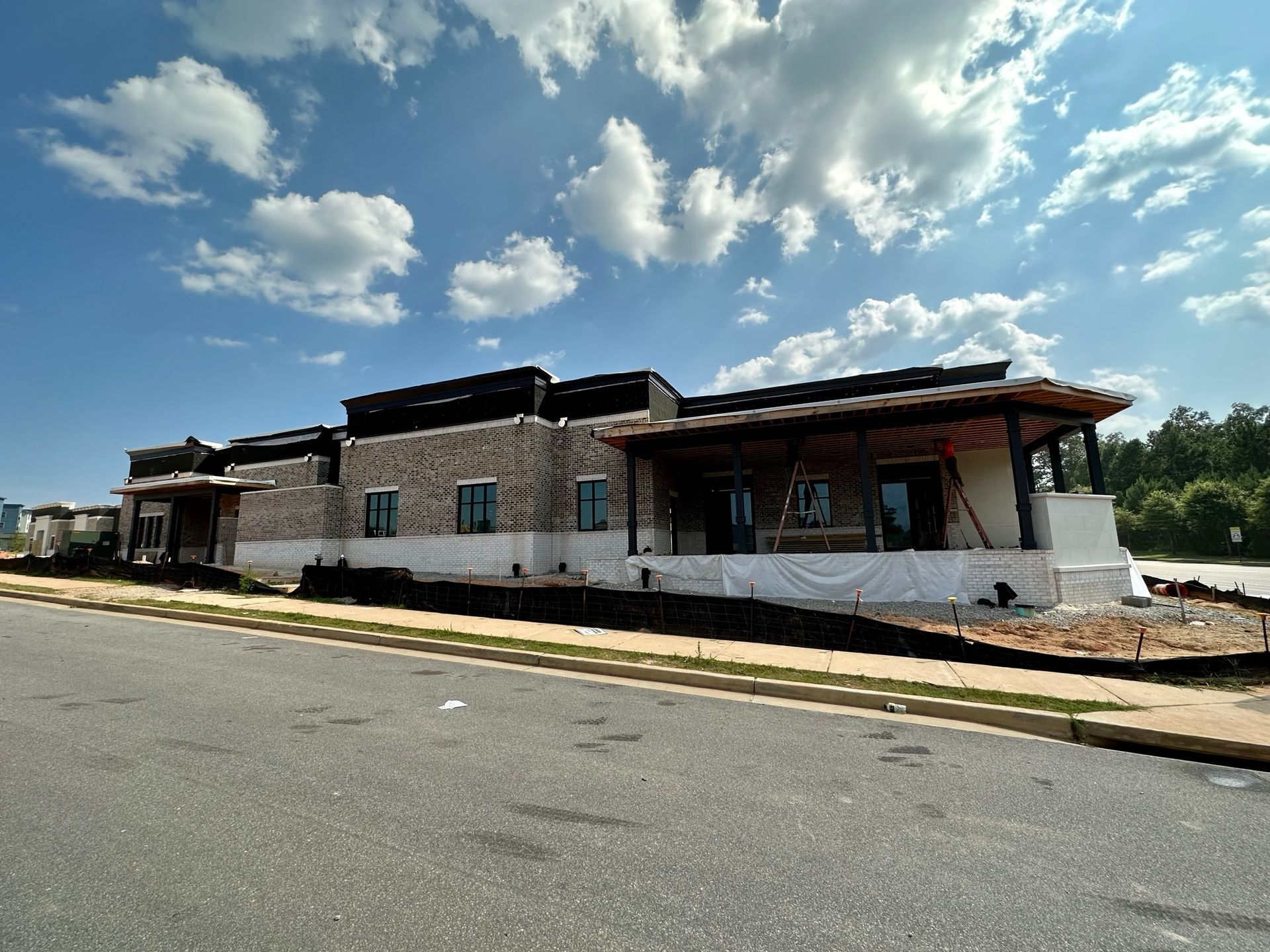 A large building is being built on the side of the road.