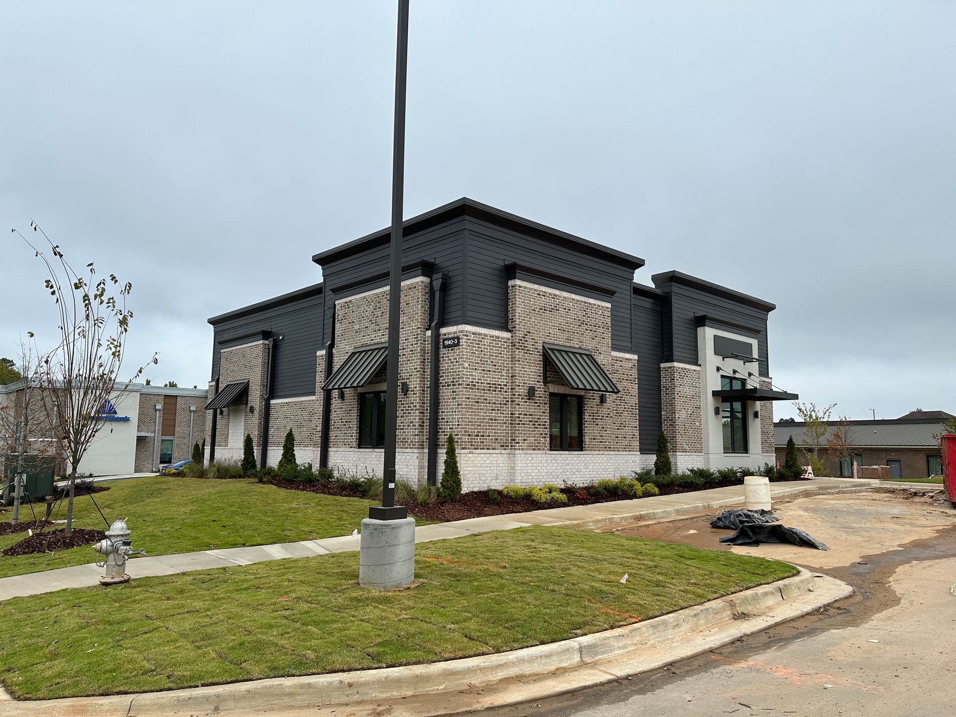 A large brick building with a fire hydrant in front of it.