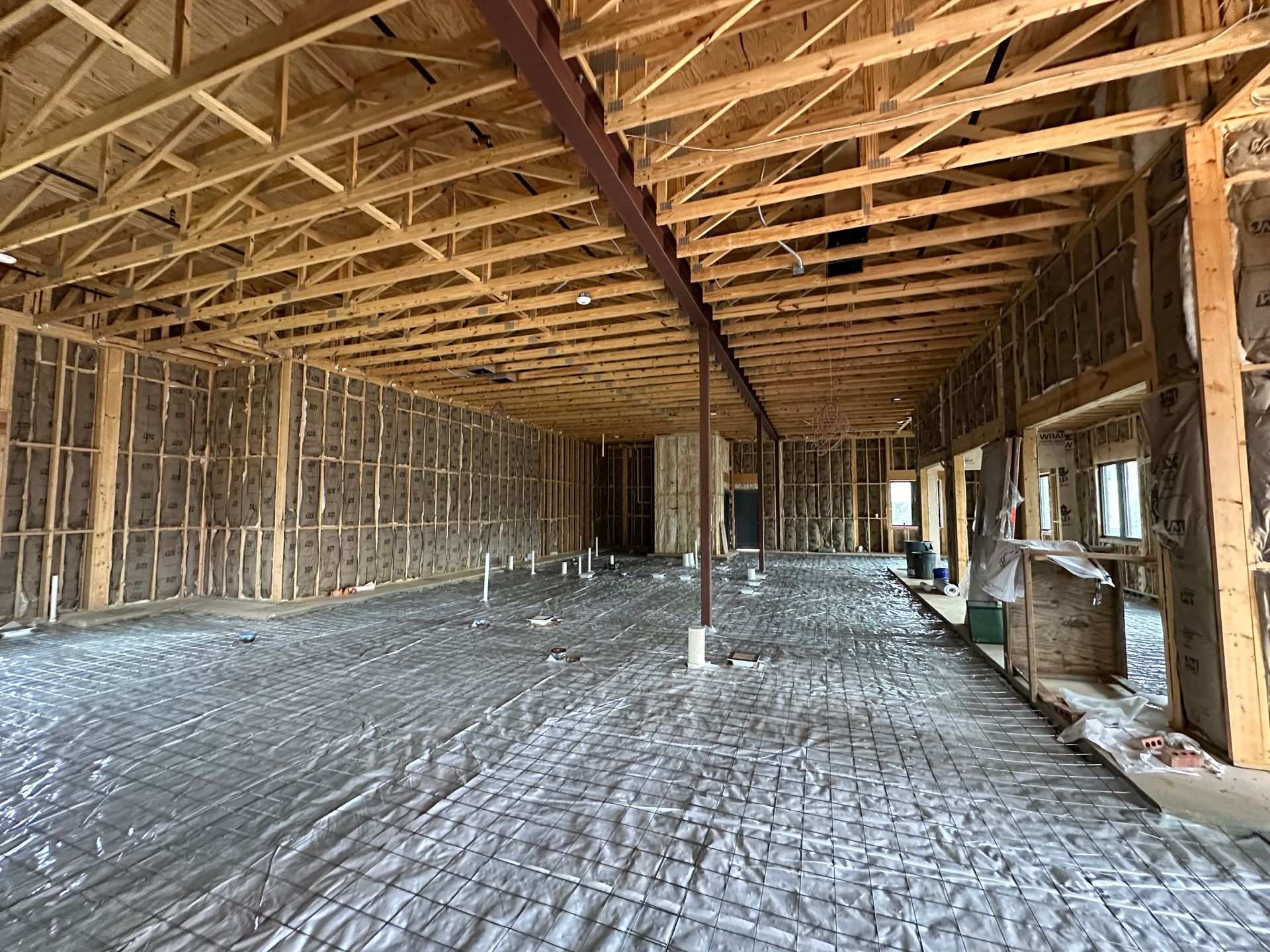 The inside of a building under construction with a lot of wooden beams.