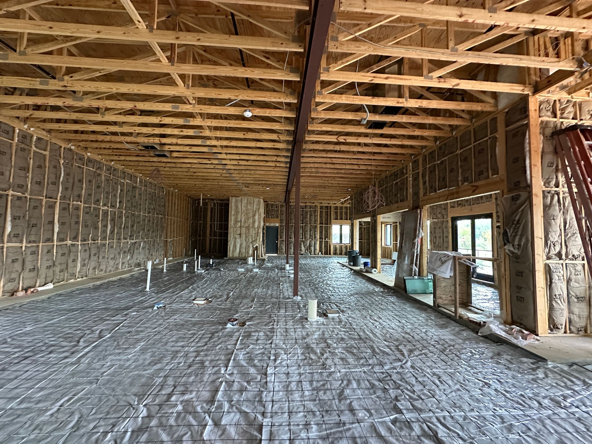 The inside of a building under construction with a lot of wooden beams.