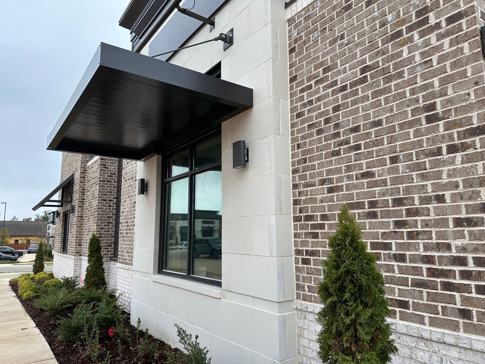 A brick building with a canopy over a window.