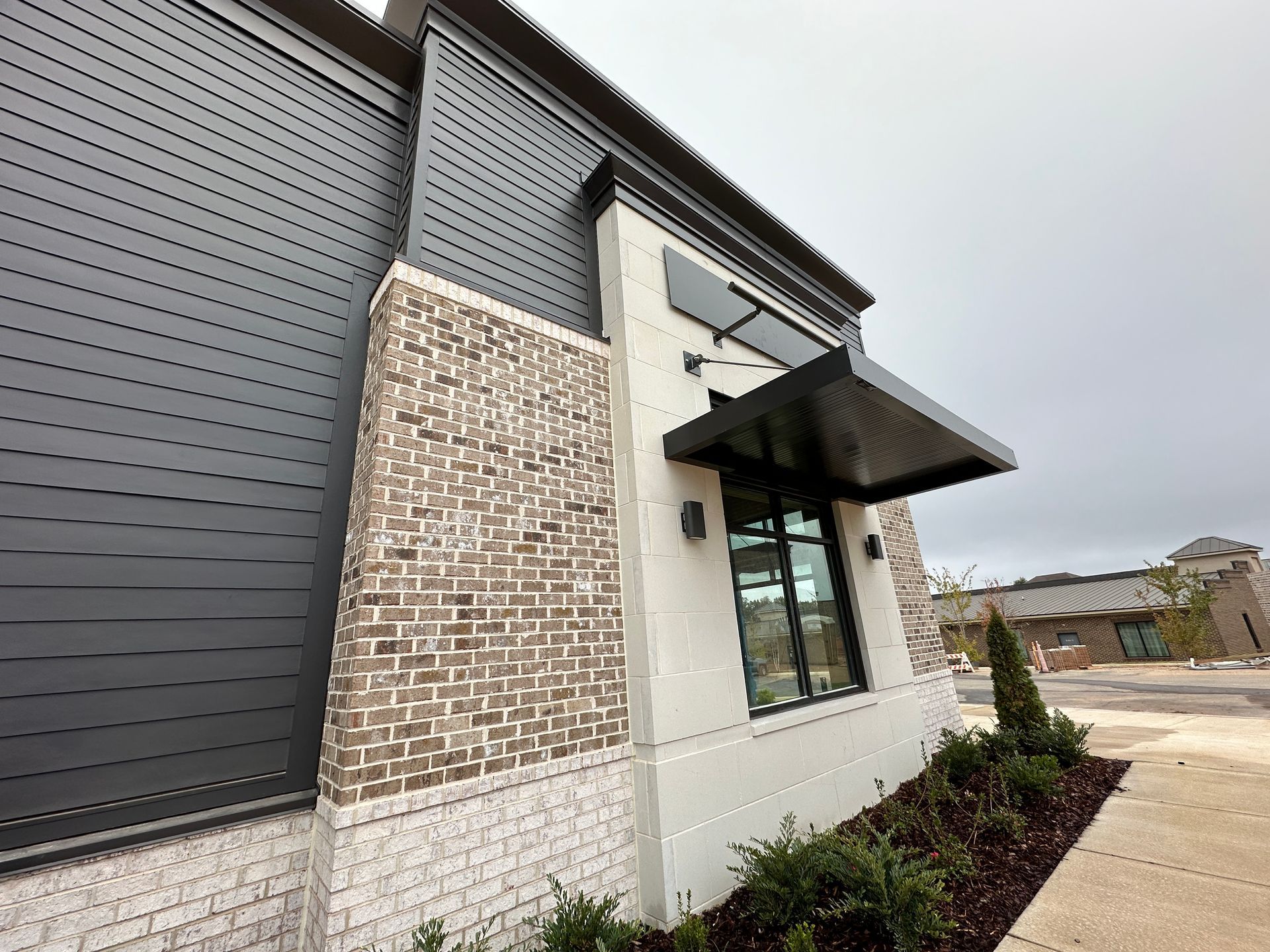 A building with a black awning on the side of it.