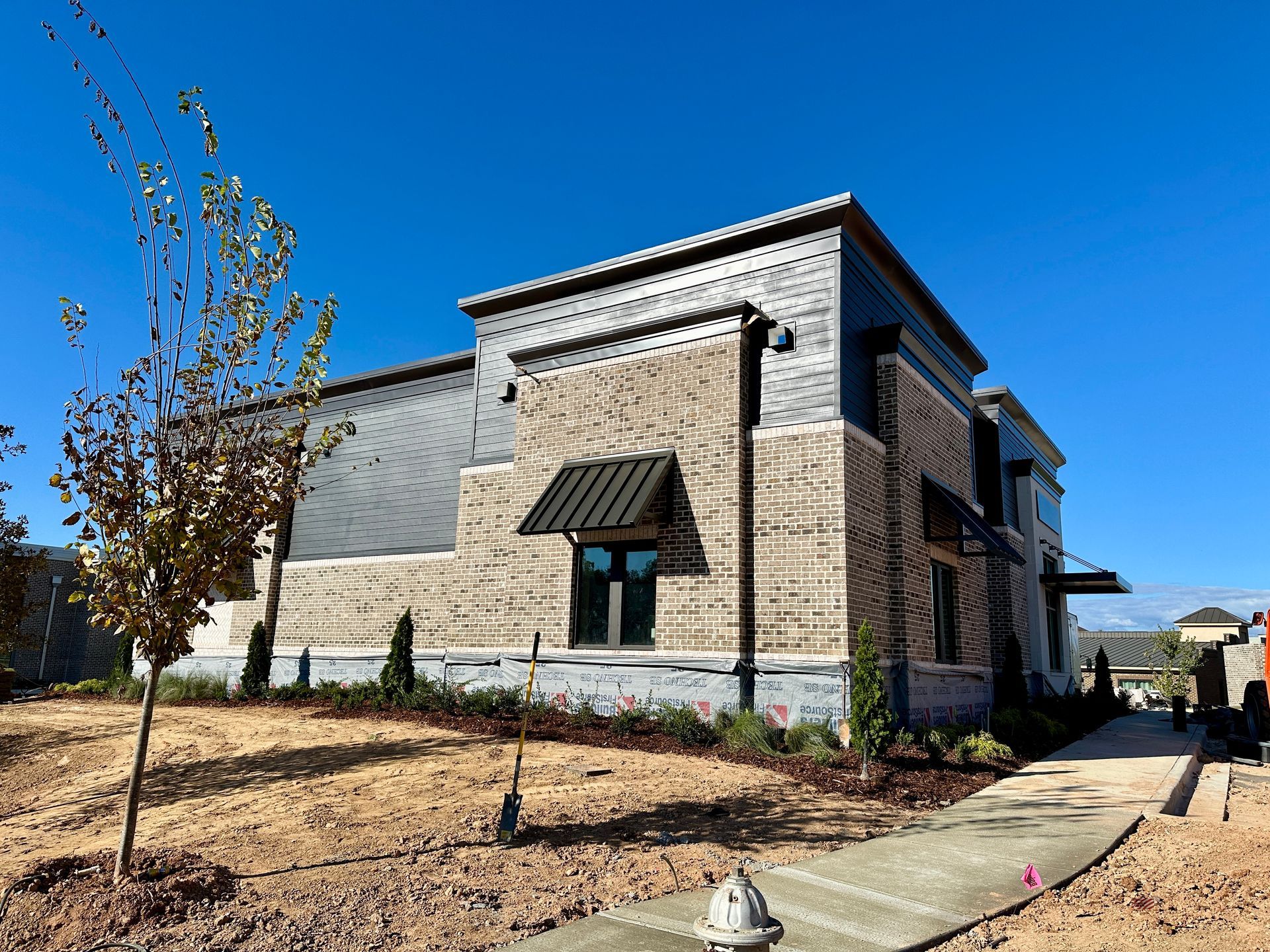 A large brick building with a fire hydrant in front of it.