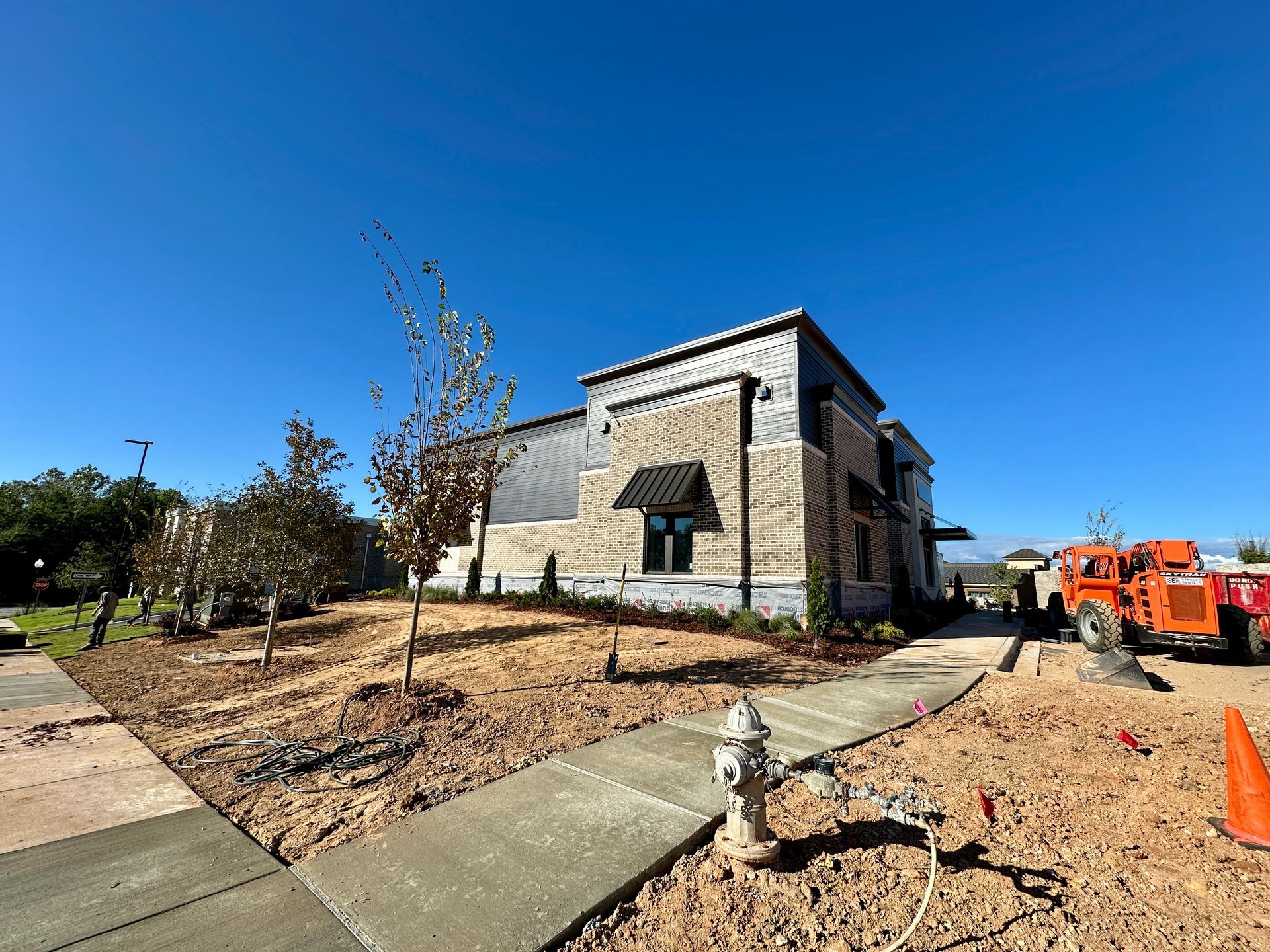 A fire hydrant is in front of a building under construction.