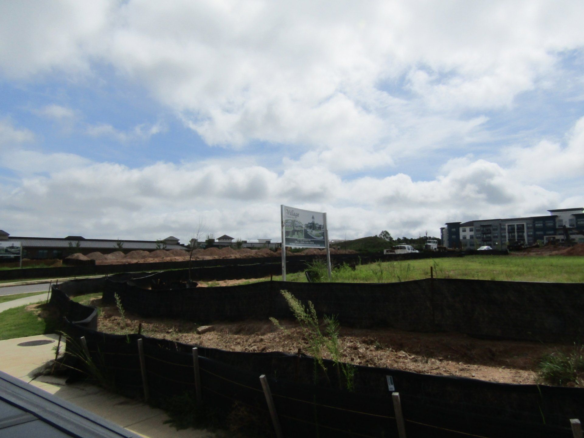 A fenced in area with a sign in the middle of it