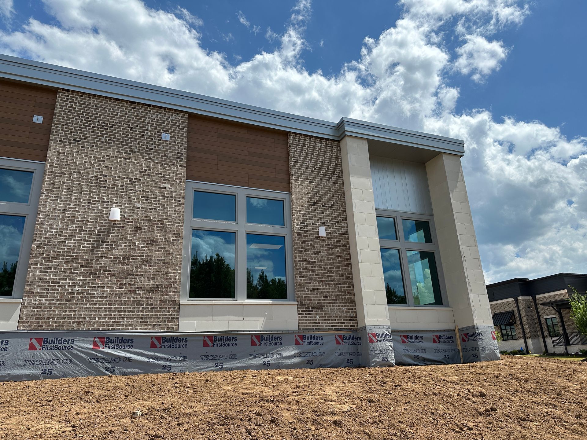 A large brick building with a lot of windows is being built.