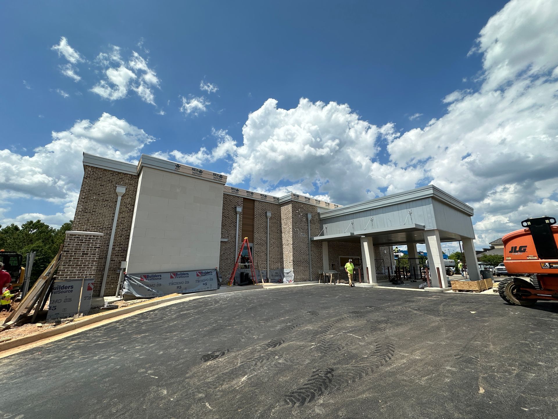 A large building is being built on a sunny day.