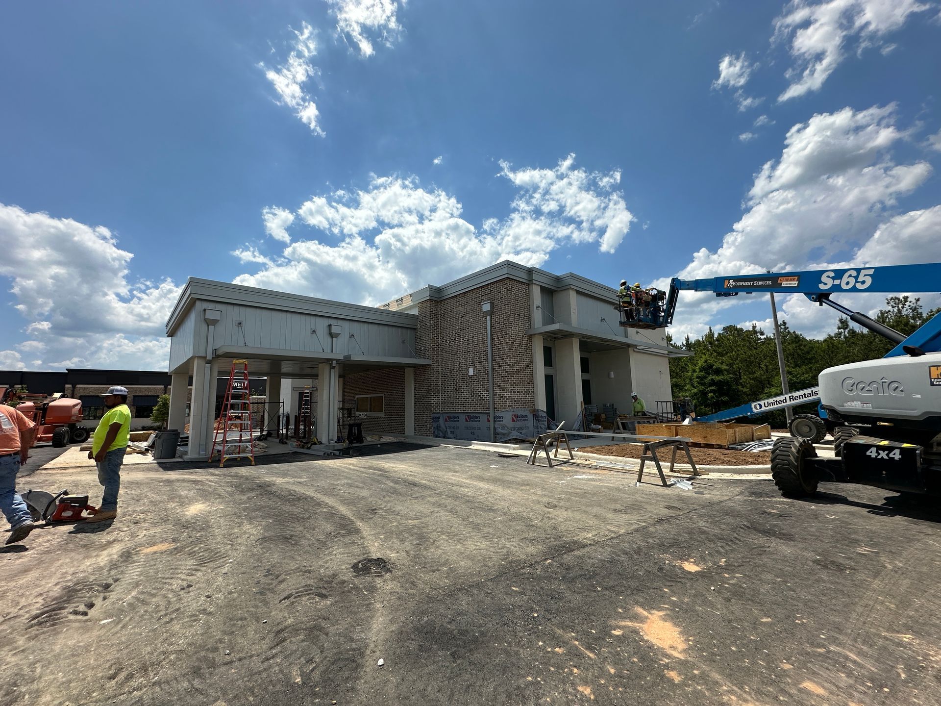 A large building is being demolished by a crane.