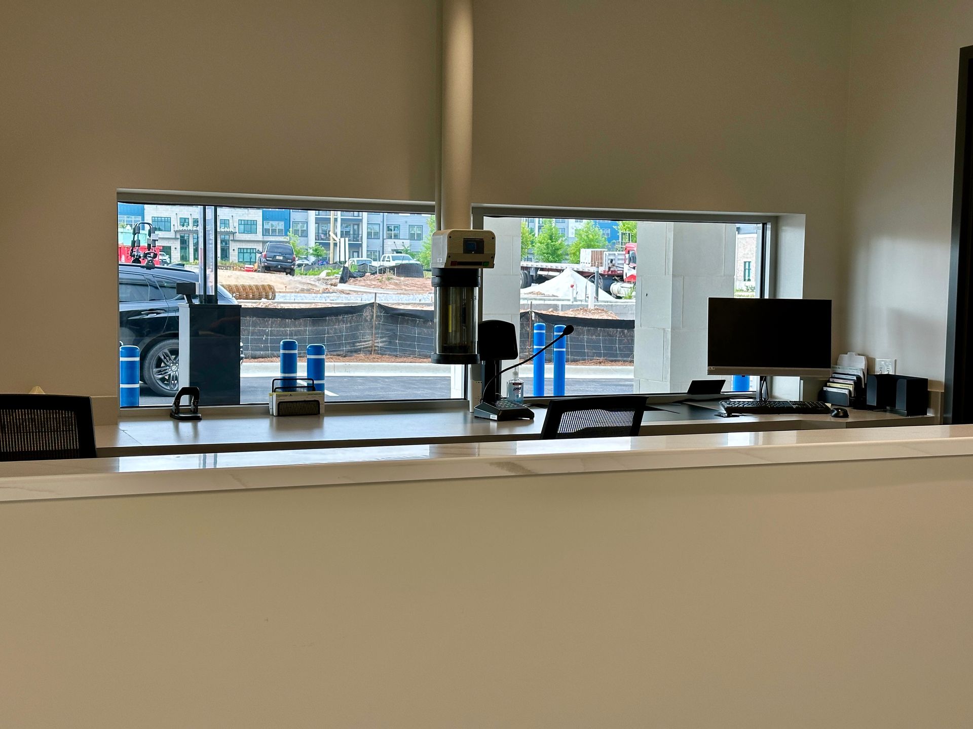 A reception desk in a car dealership with a computer on it.