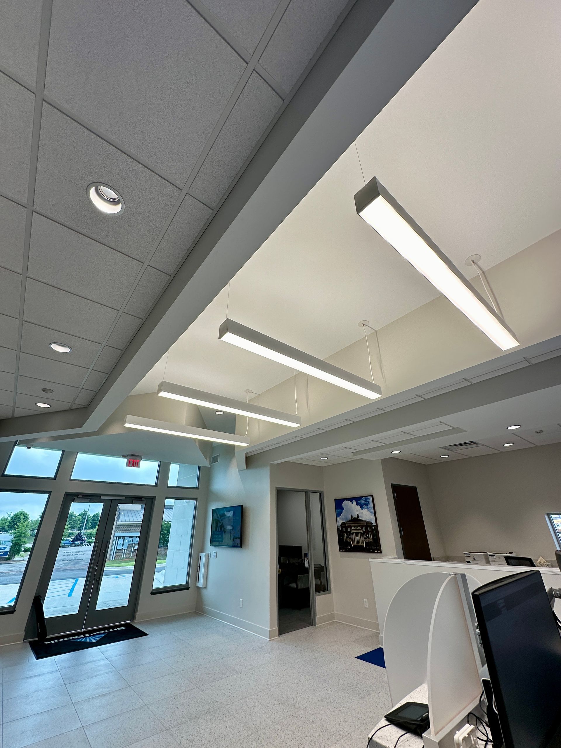 A large room with a lot of windows and lights on the ceiling.