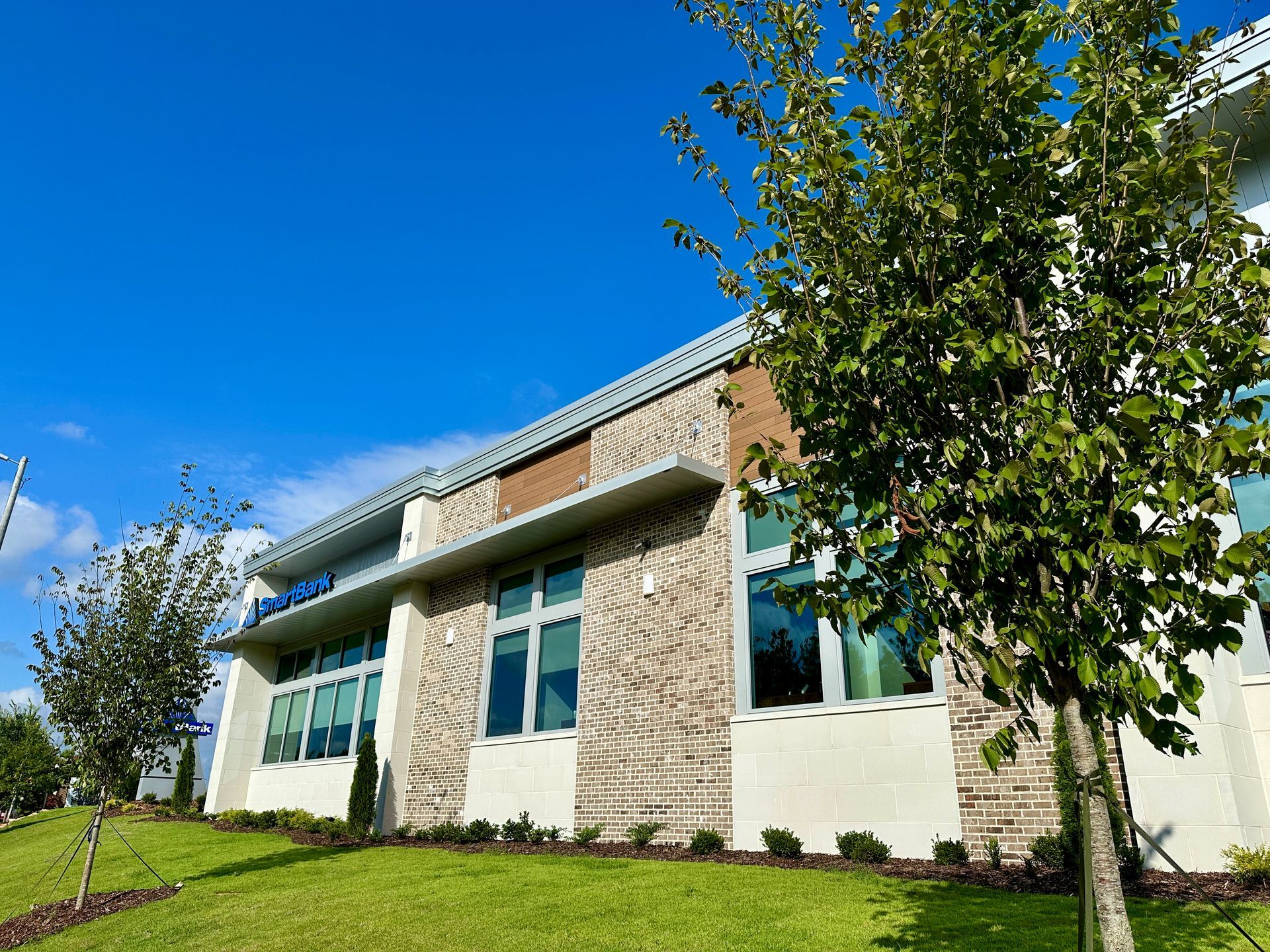A large building with a lot of windows and trees in front of it.