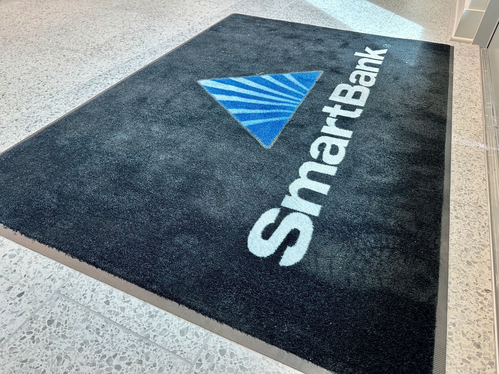 A black mat with a smartbank logo on it.