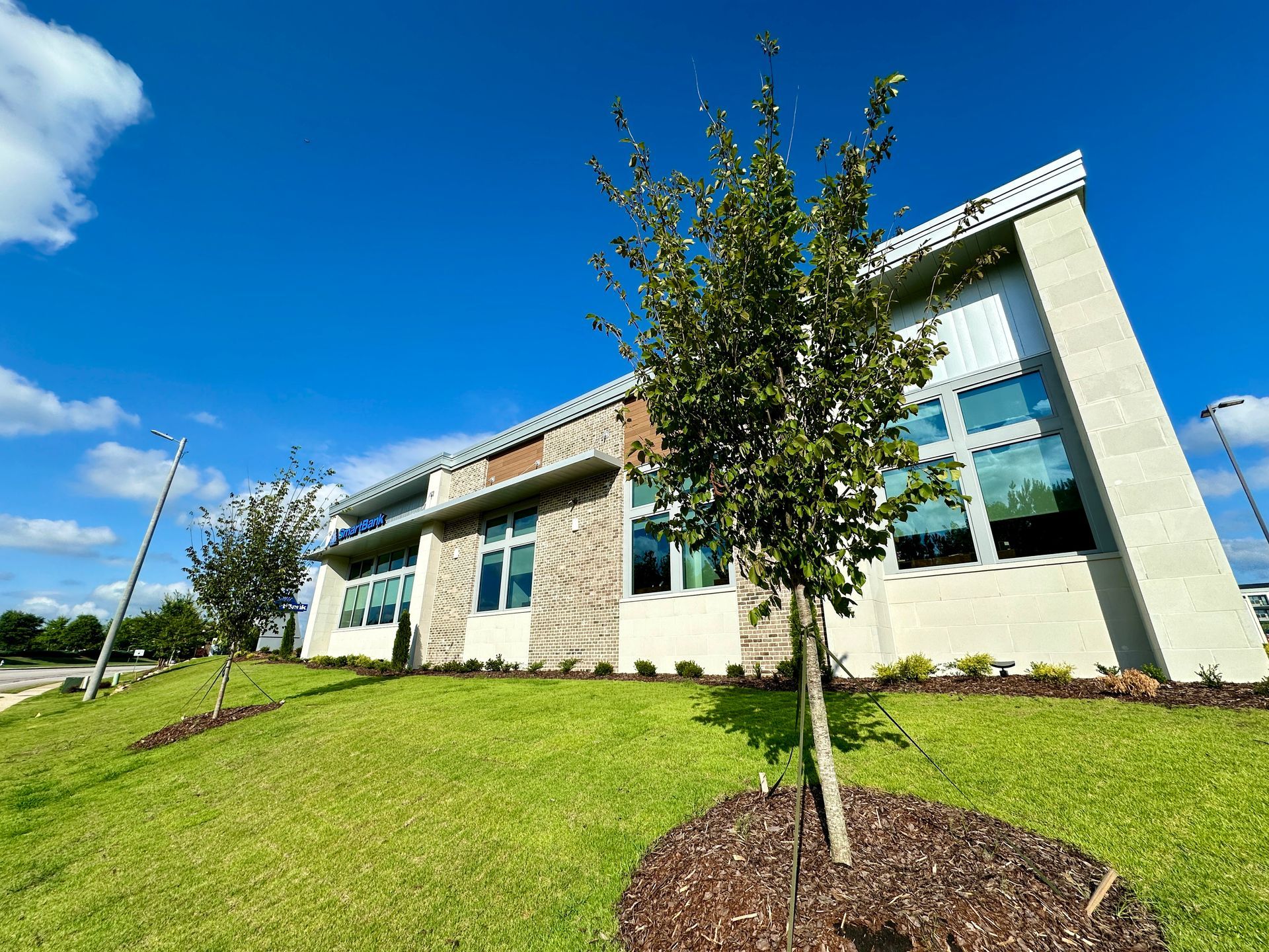 A large building with a lot of windows and trees in front of it.