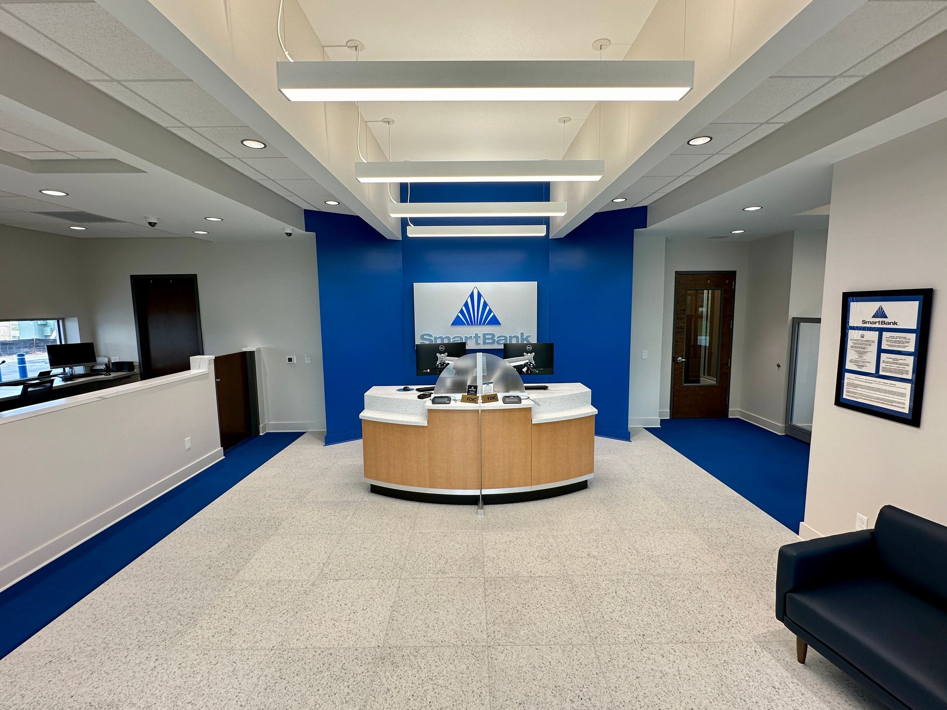 A large room with a blue wall and a wooden desk