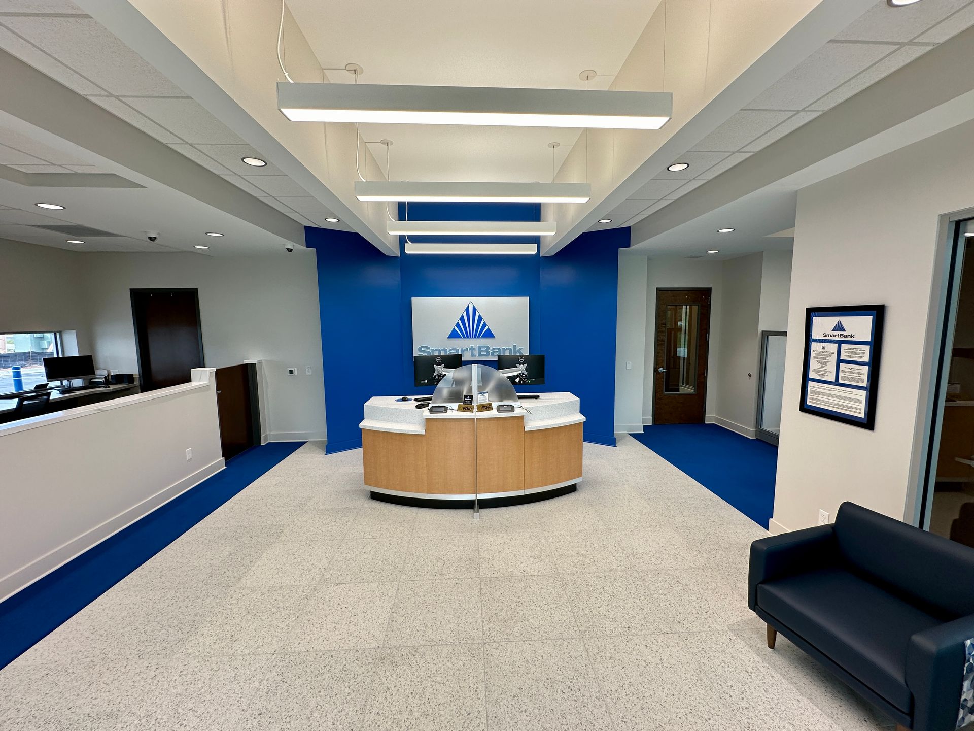 A large room with a couch and a desk in it