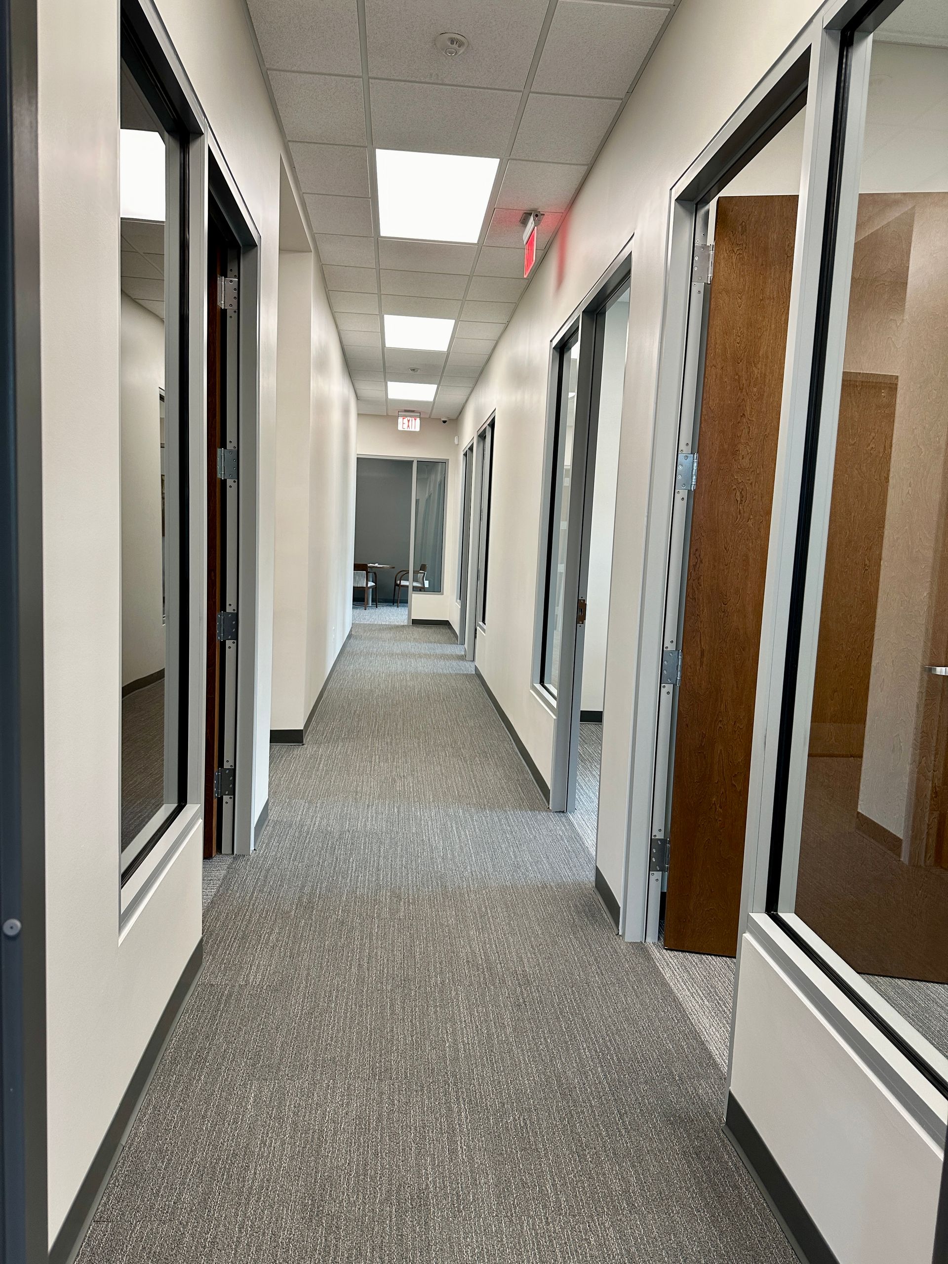 A long hallway with a lot of windows and doors