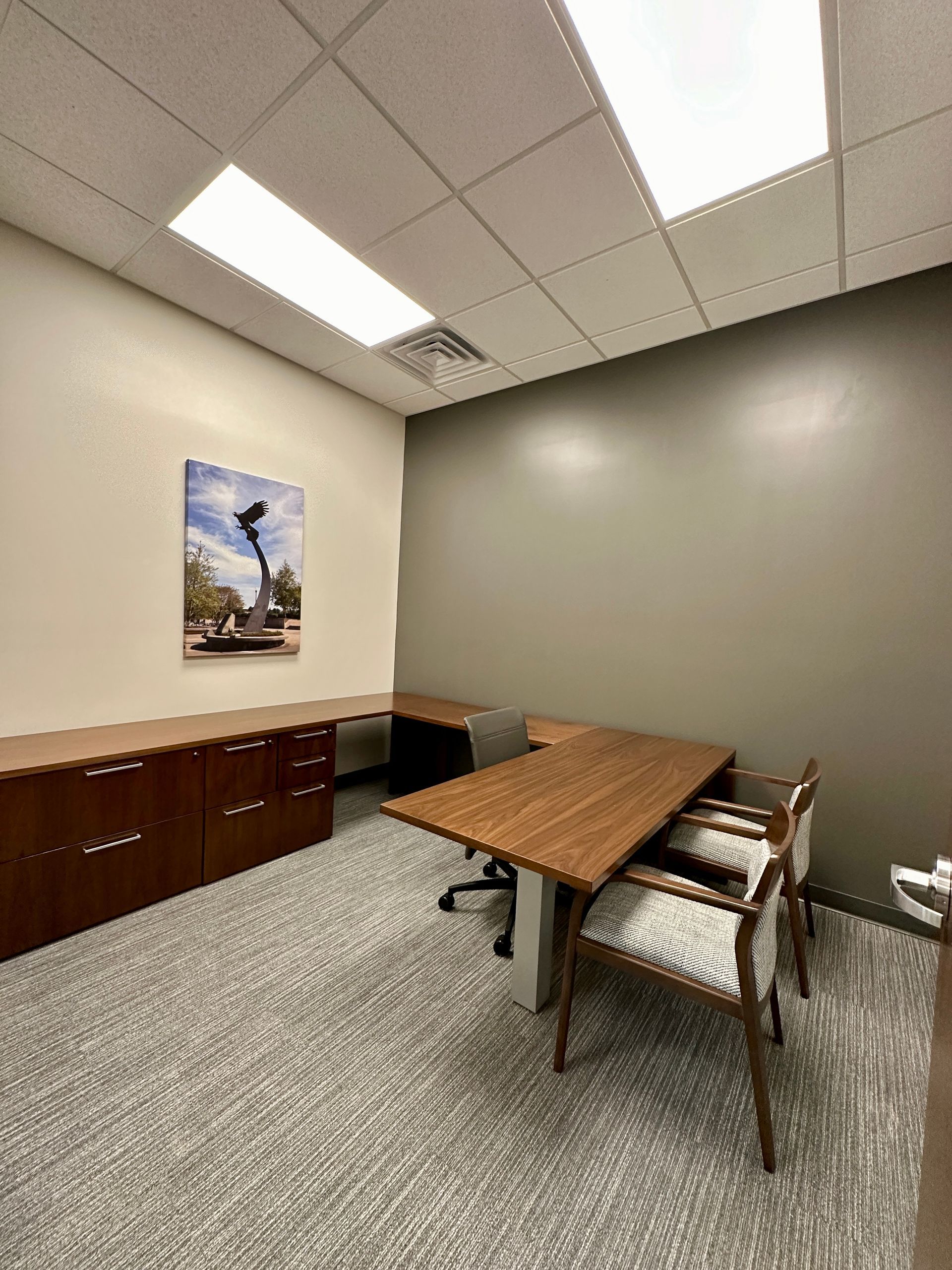 A small office with a wooden table and chairs.
