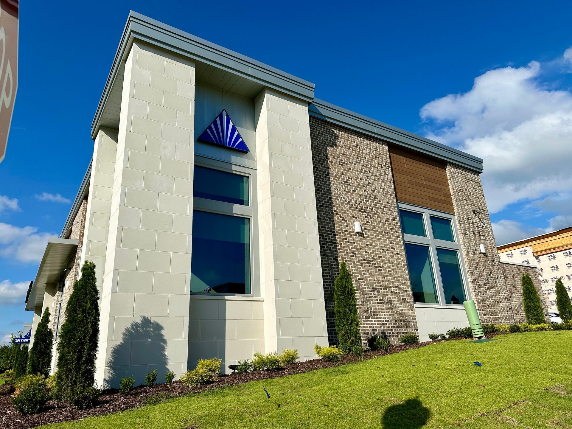 A large white building with a blue triangle on the top of it