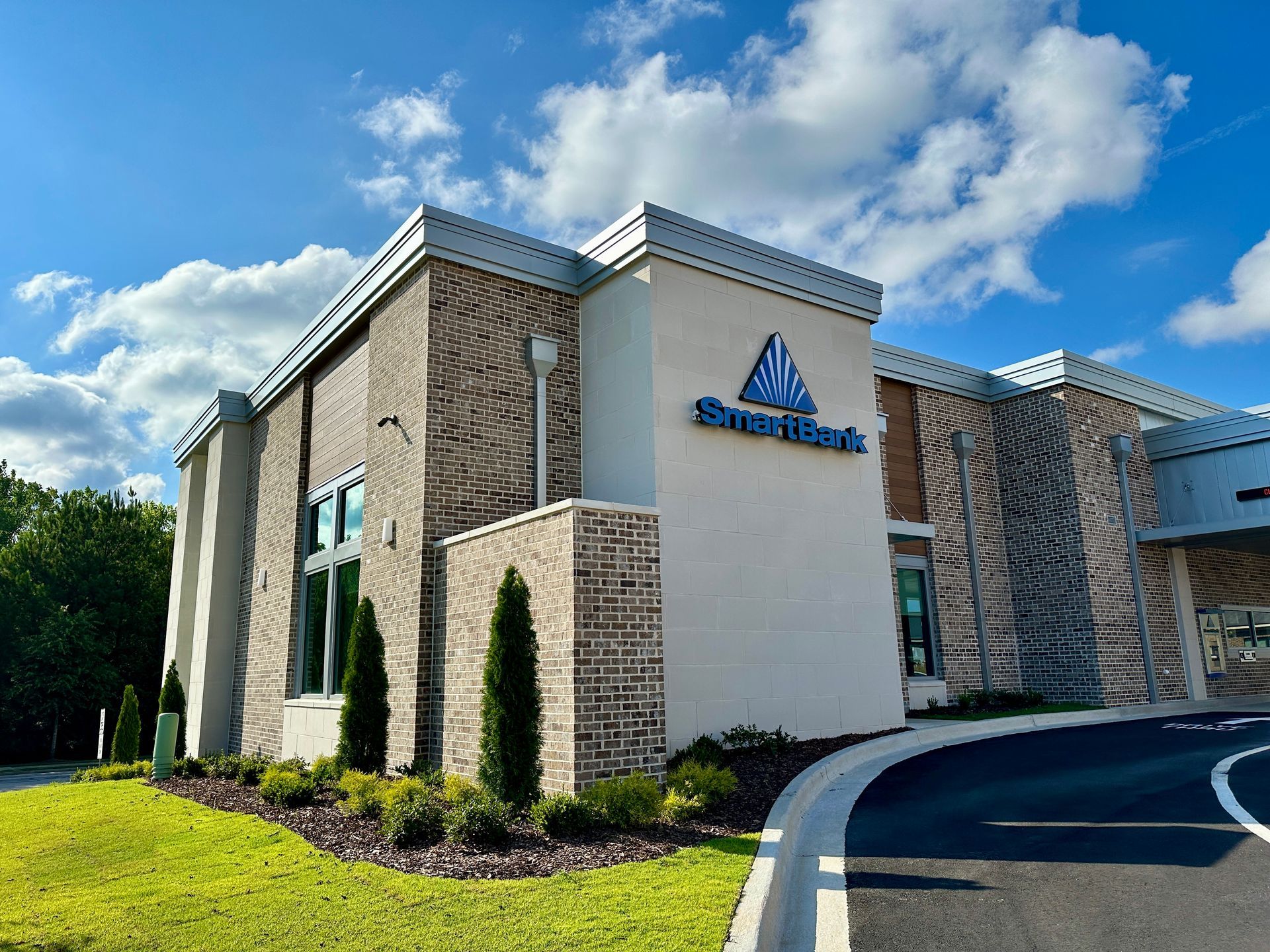 A white building with a blue sign that says short bank