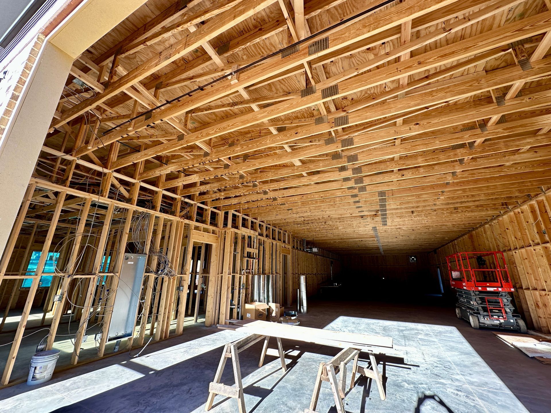 Interior of a building under construction, wooden framing visible.