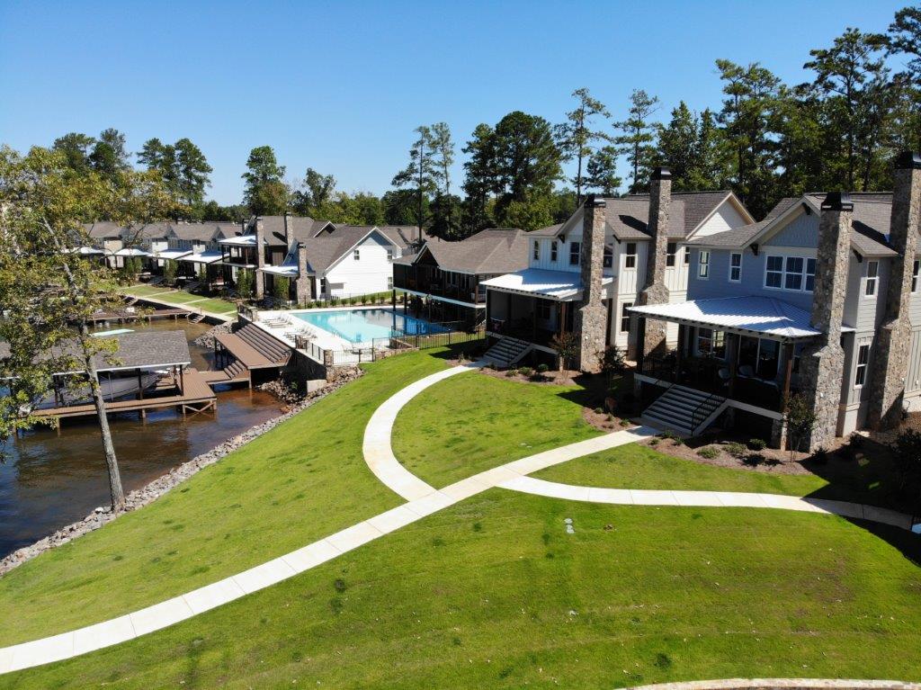 An aerial view of a residential area with houses and a pool