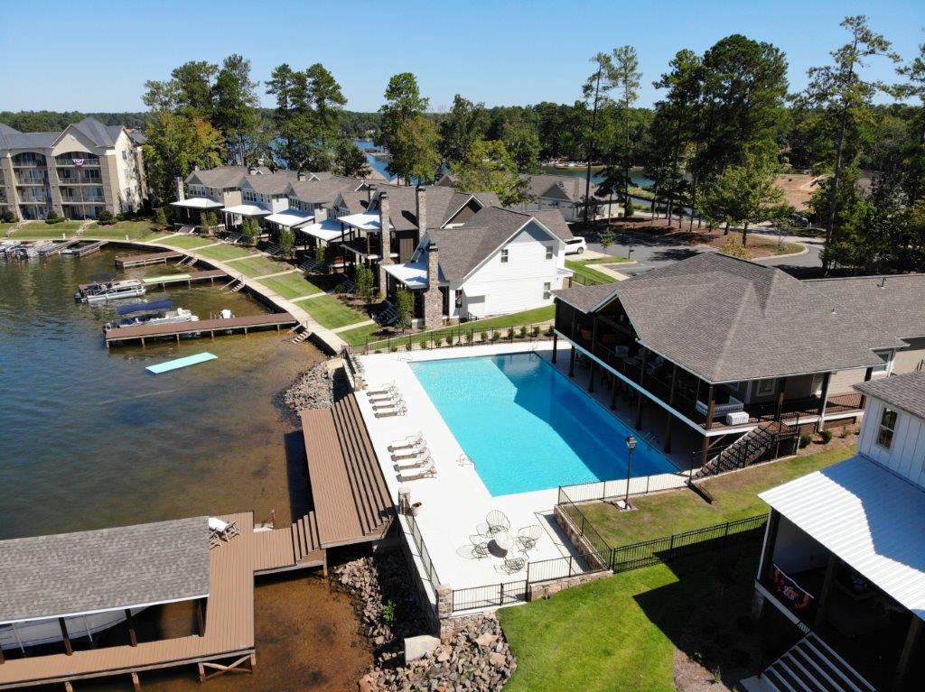An aerial view of a large swimming pool surrounded by houses