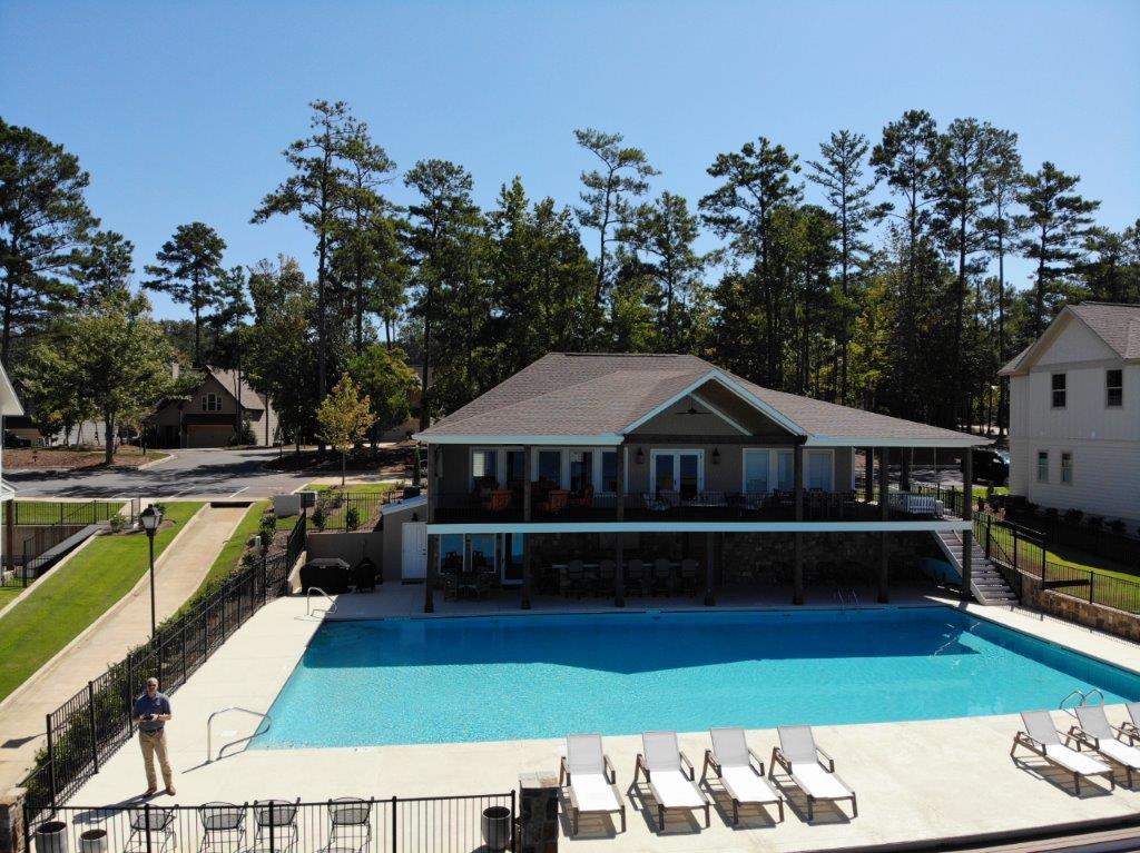 A large swimming pool in front of a house