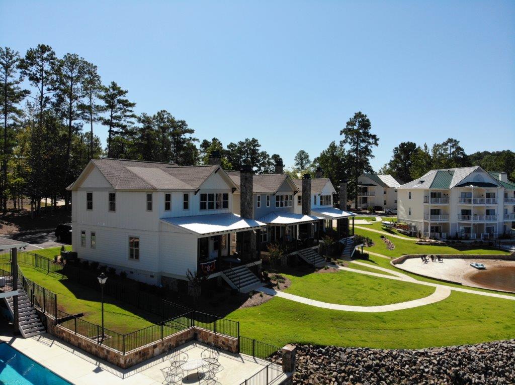 An aerial view of a house with a swimming pool in front of it