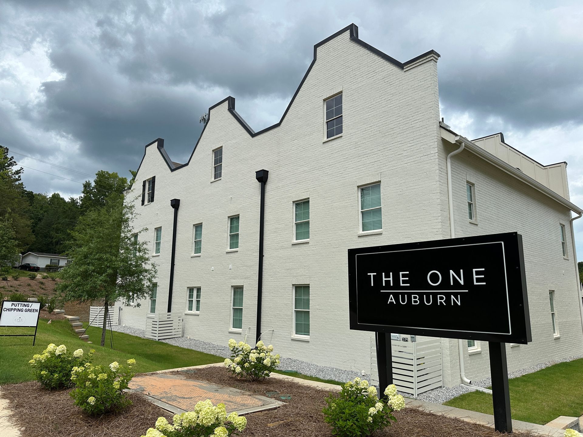 A large brick building under construction with a fence around it.