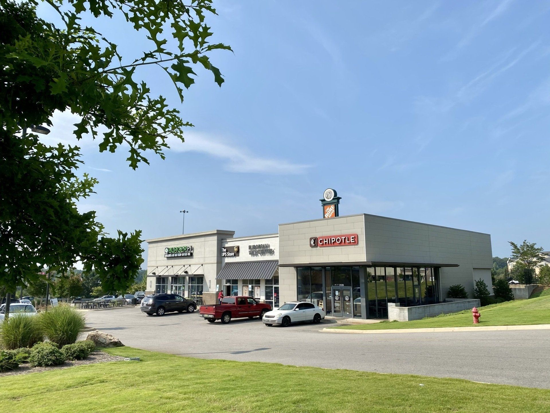 A large building with a red truck parked in front of it