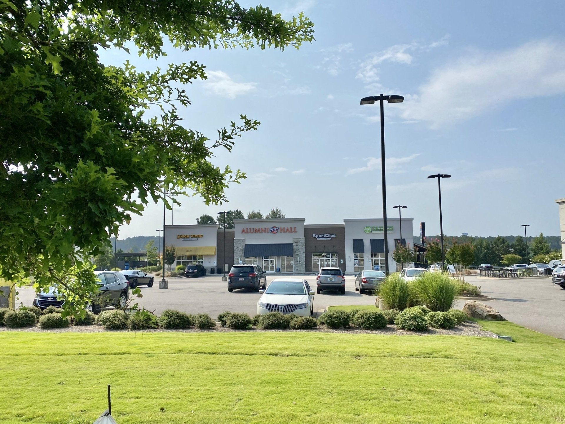 A parking lot with cars parked in front of a store.