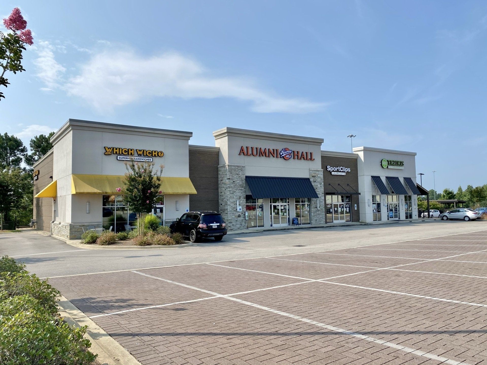 A group of stores are sitting next to each other in a parking lot.