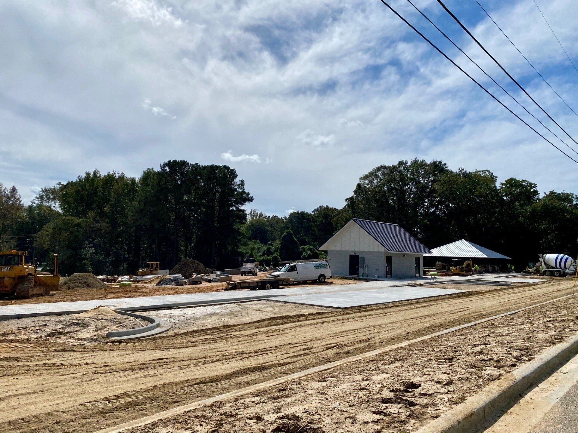 A construction site with a lot of dirt and trees in the background.