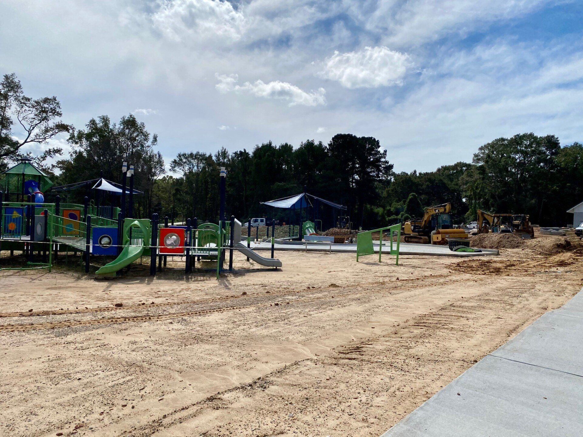 A playground is being built in a dirt field.