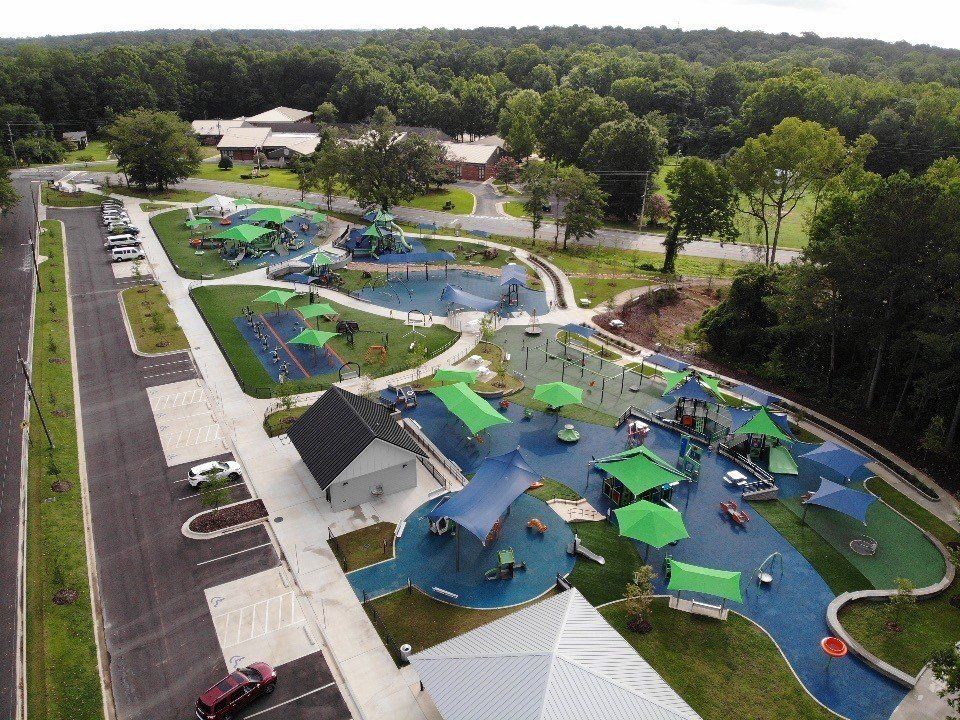 An aerial view of a playground with green umbrellas