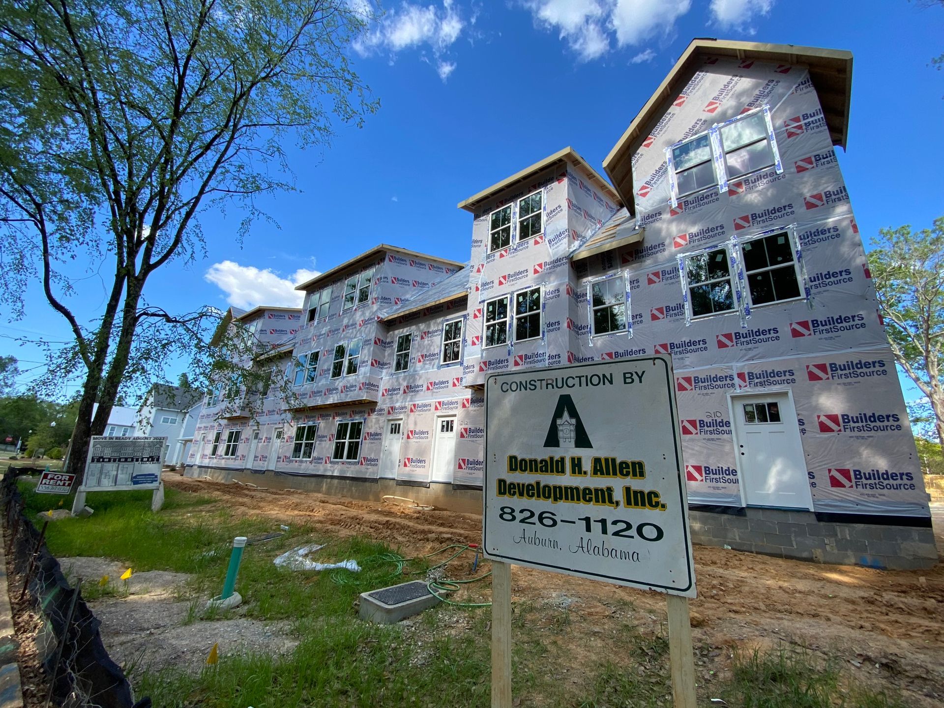 A building under construction with a sign in front of it.