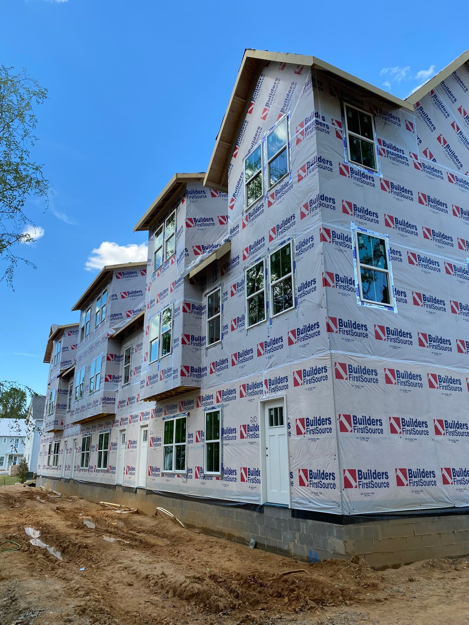 A large apartment building is being built with a lot of windows.