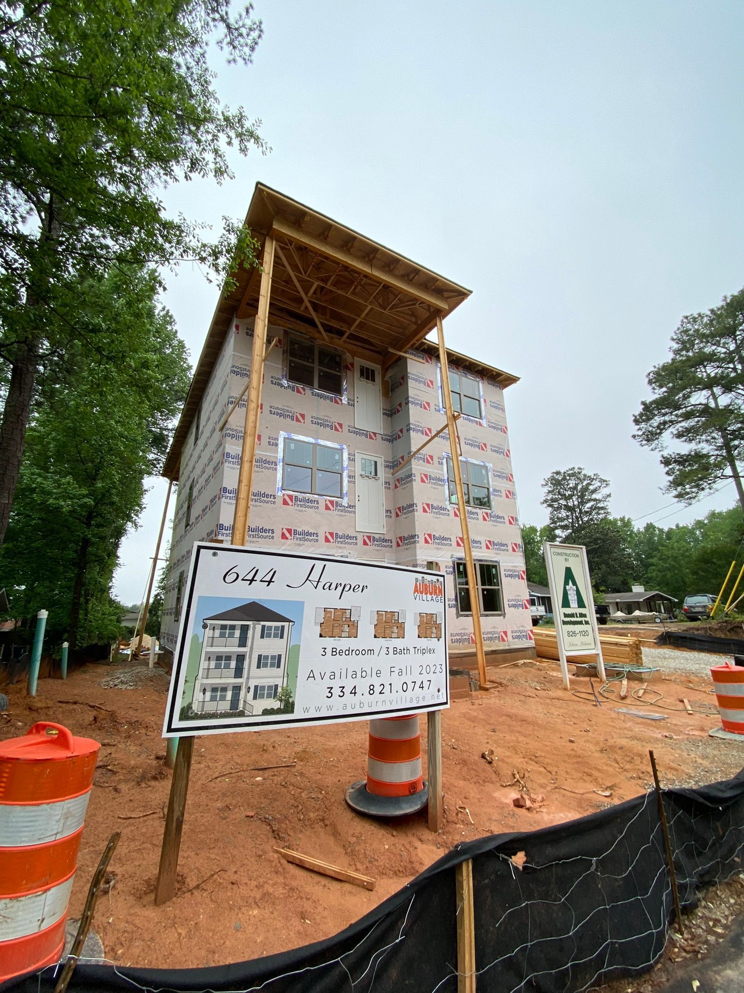 A building under construction with a sign in front of it.