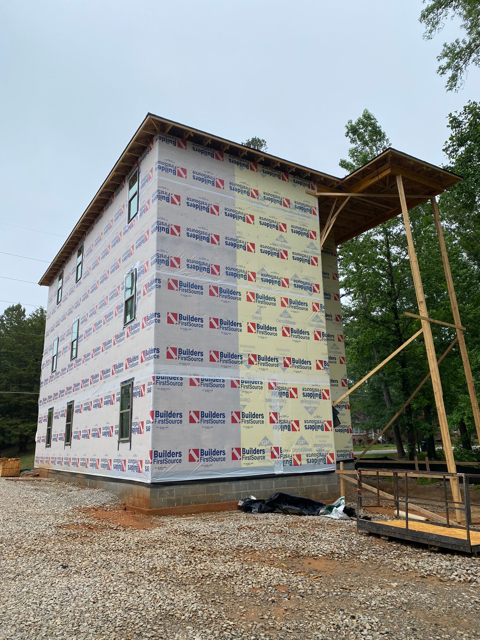 A large building is being built in the middle of a forest.