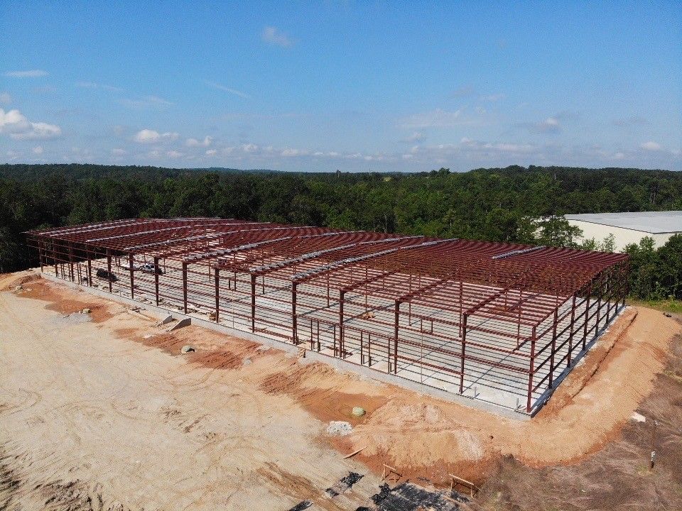 An aerial view of a large metal building under construction.