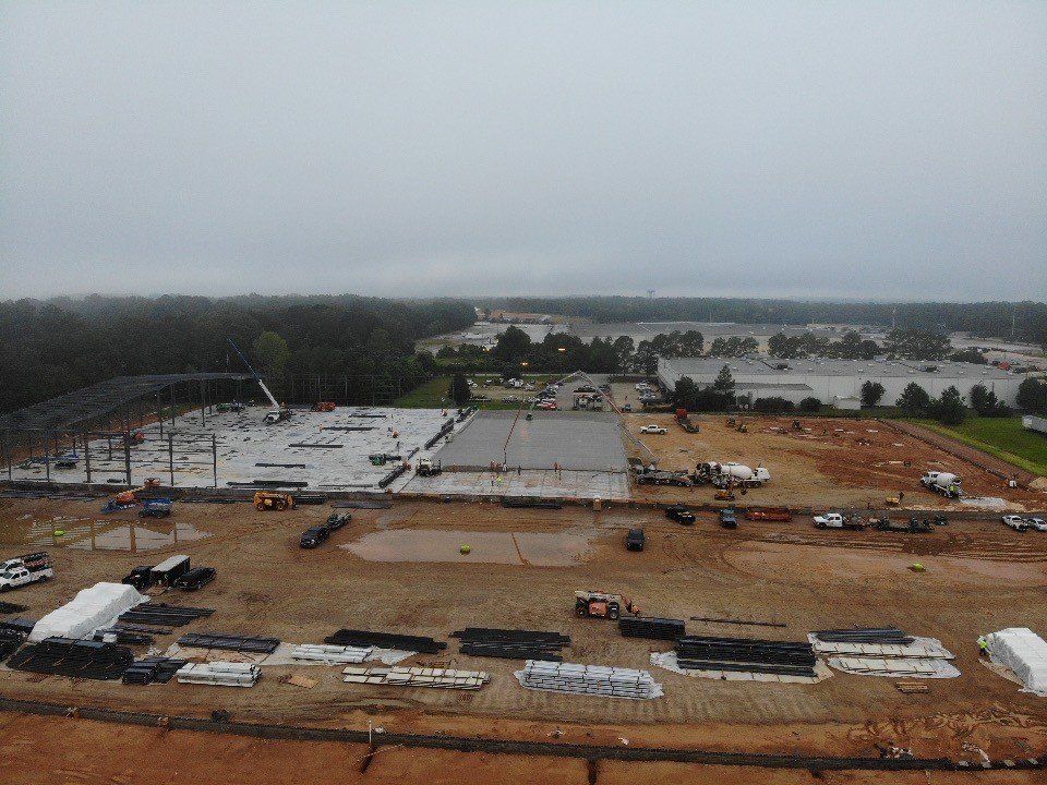 An aerial view of a large construction site on a cloudy day.