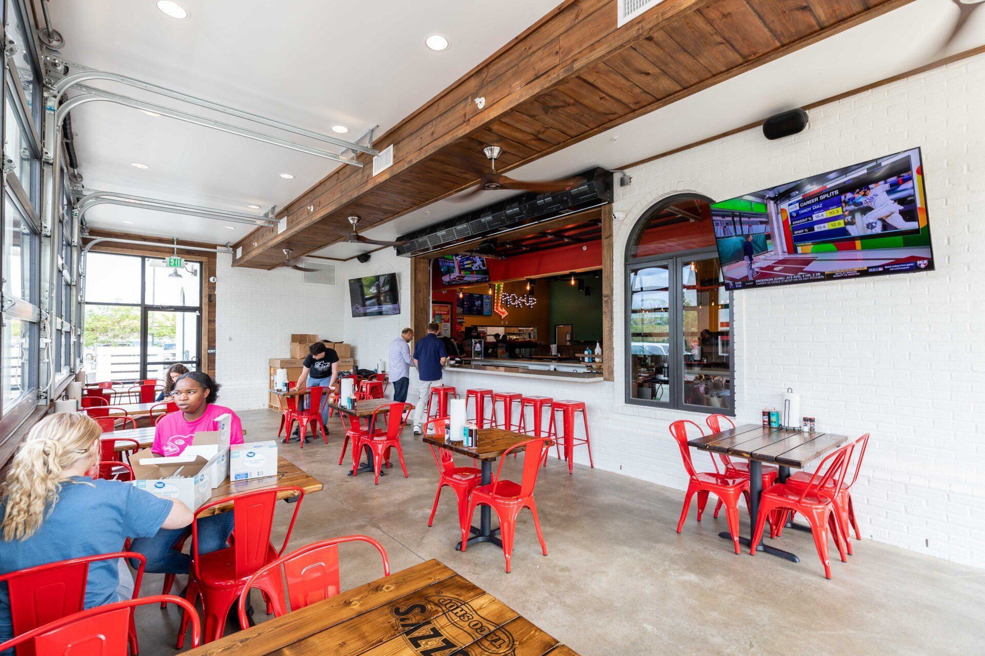 A group of people are sitting at tables in a restaurant.