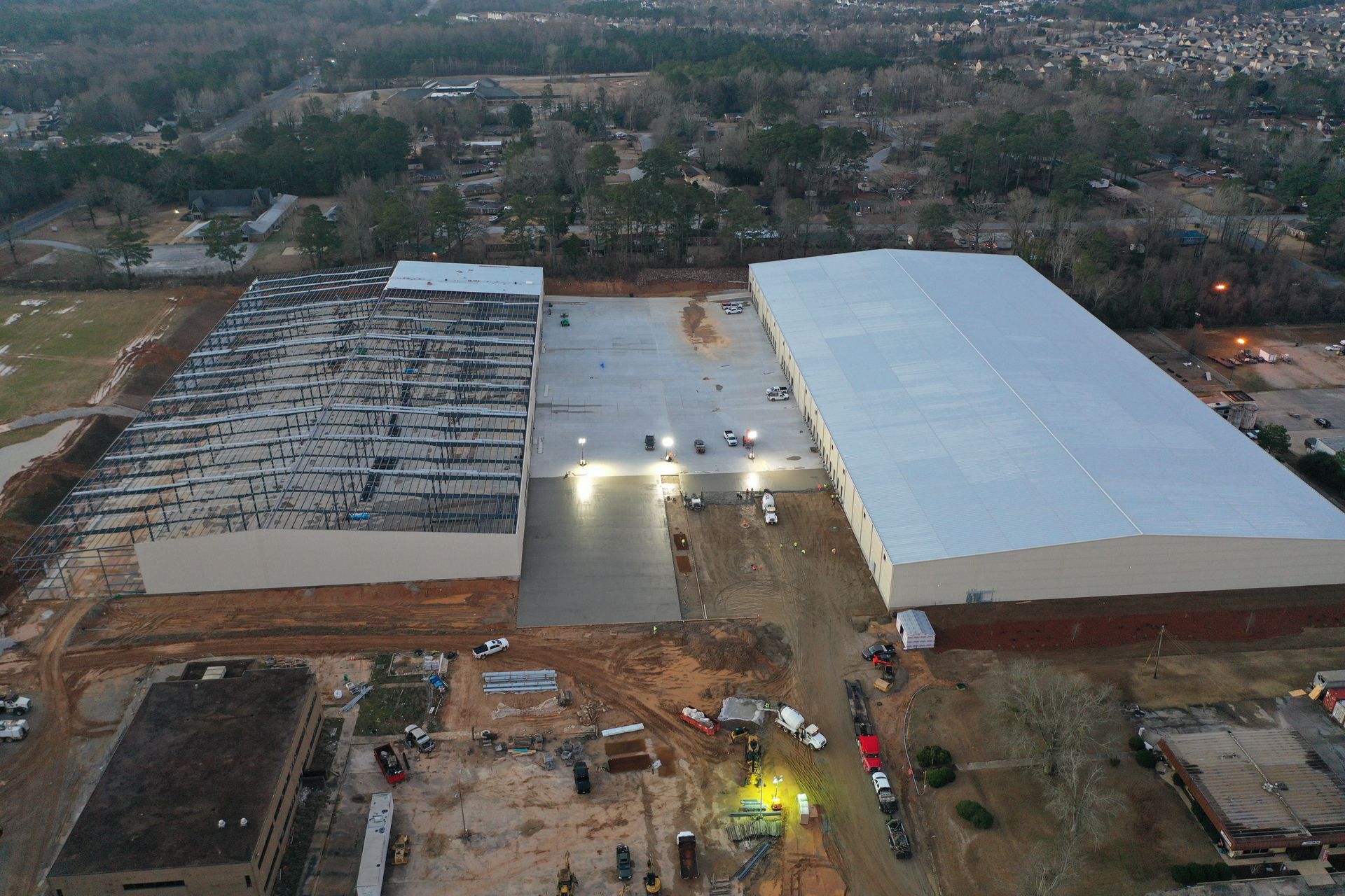 An aerial view of a large building under construction in a city.