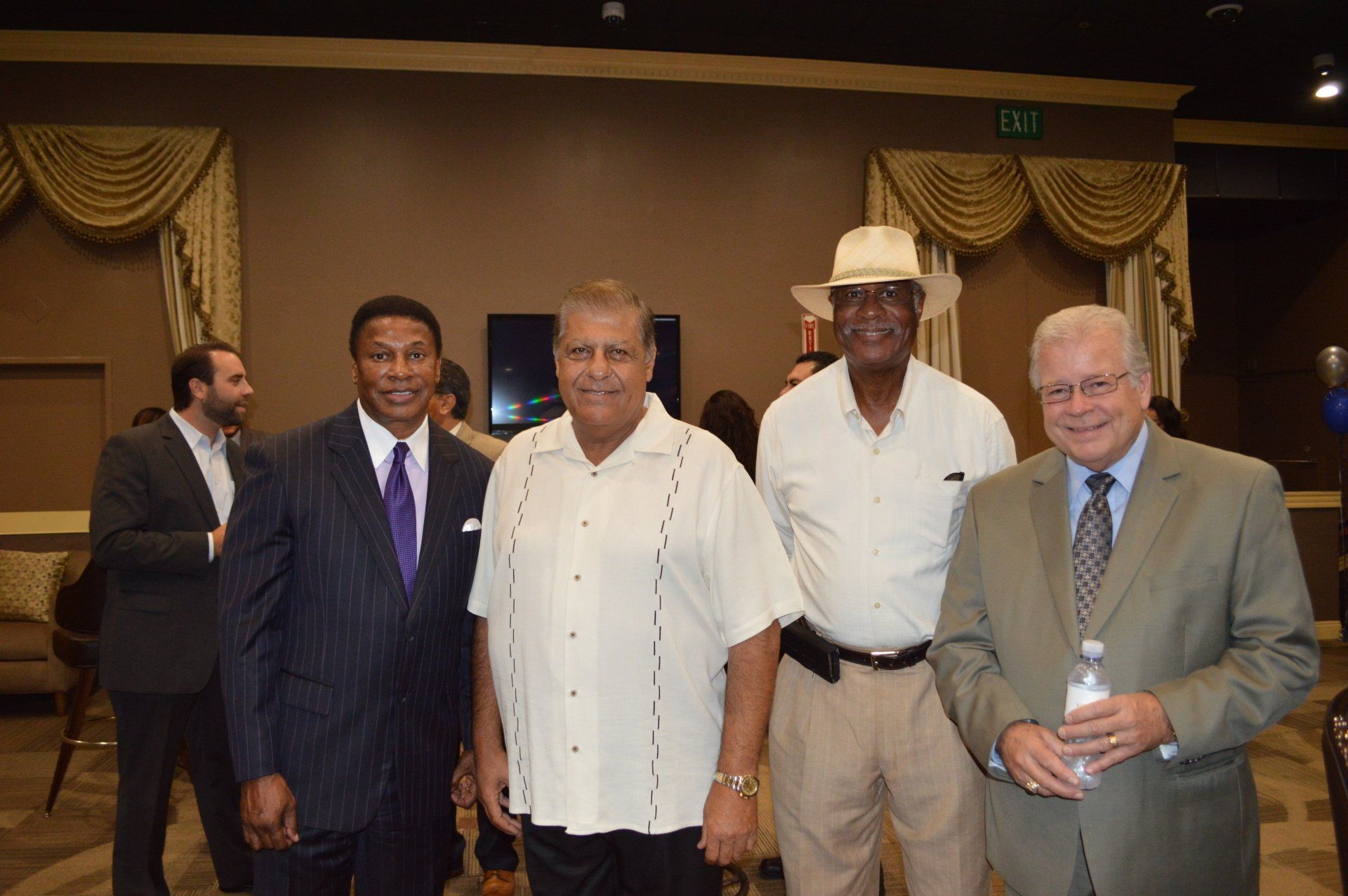 A group of men are posing for a picture in a room.